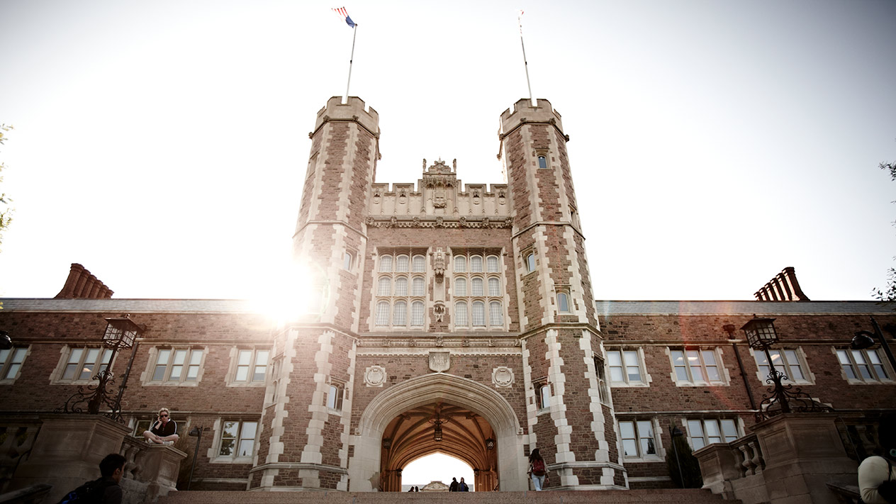 Image of Danforth Campus main building with the Sun setting behind it.
