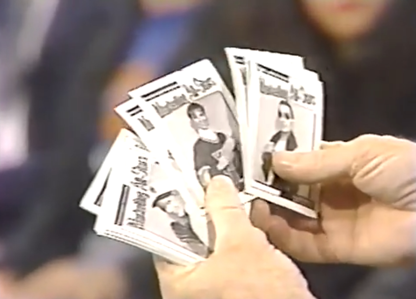Phil Donahue shows the Marketing All Stars baseball cards to his audience.