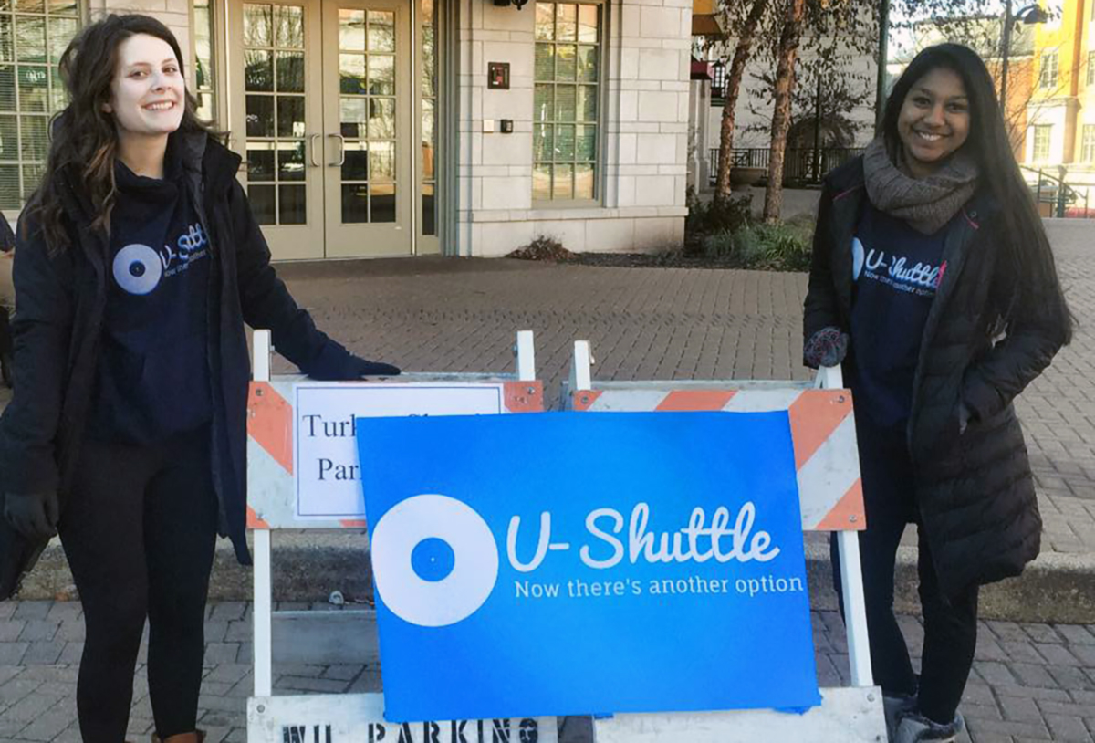 Students pose in front of U-Shuttle