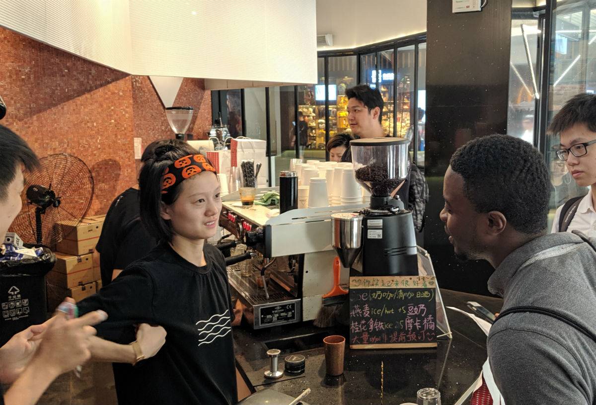 Duckenson Joseph, MBA ’21, questioning a store clerk at one of the Shanghai coffee shops he visited with his counterparts on team 10.