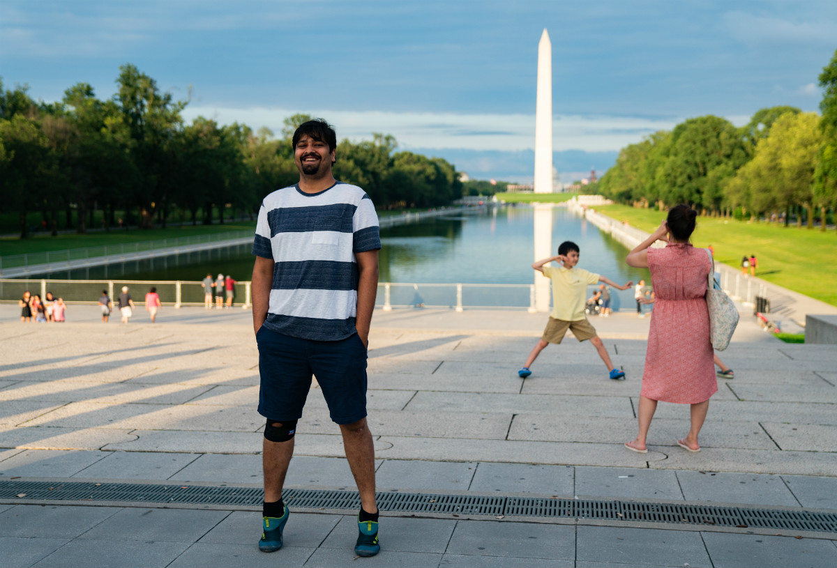 Shantanu Pande stands at the Lincoln Memorial facing the Washington Monument in Washington DC.