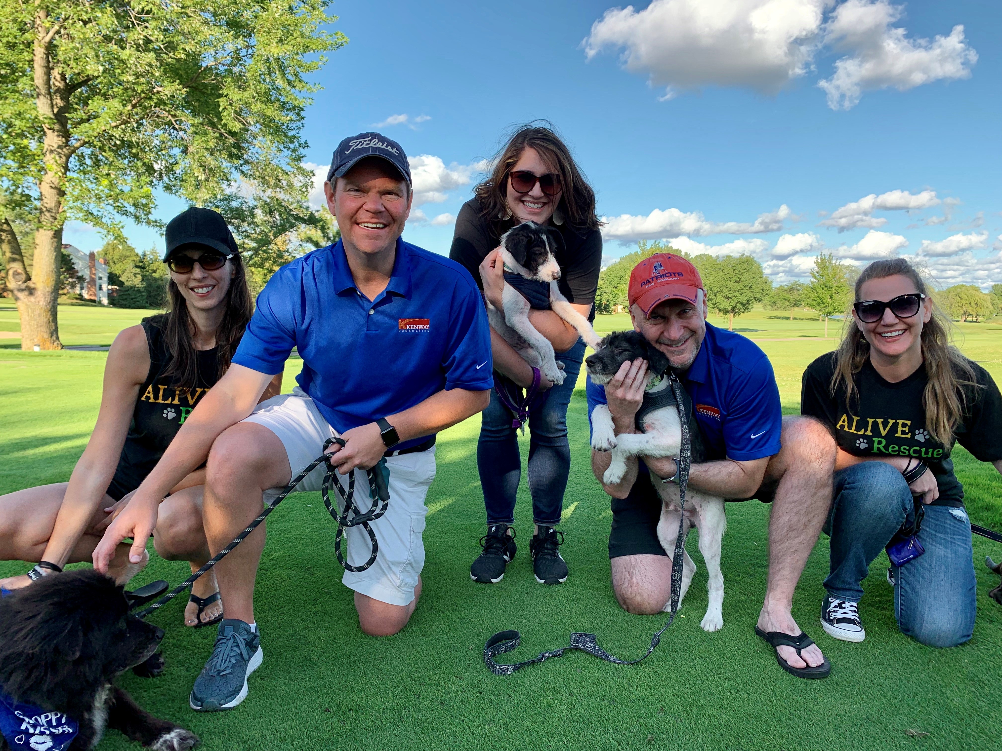 Kenway’s Consulting’s Matt Kueker, left, and Brian King are pictured with adoptable dogs and, from left to right, ALIVE Rescue’s Kristen Gerali, Margo Strebig and Hannah Nicolet at Kenway ‘s annual fundraiser for the local nonprofit.
