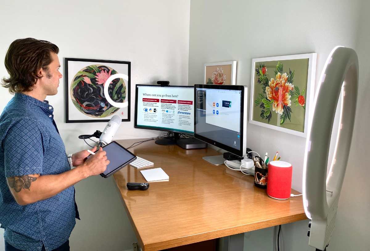 Olin’s Andrew Knight, professor of organizational behavior, demonstrating a successful at-home tech setup.