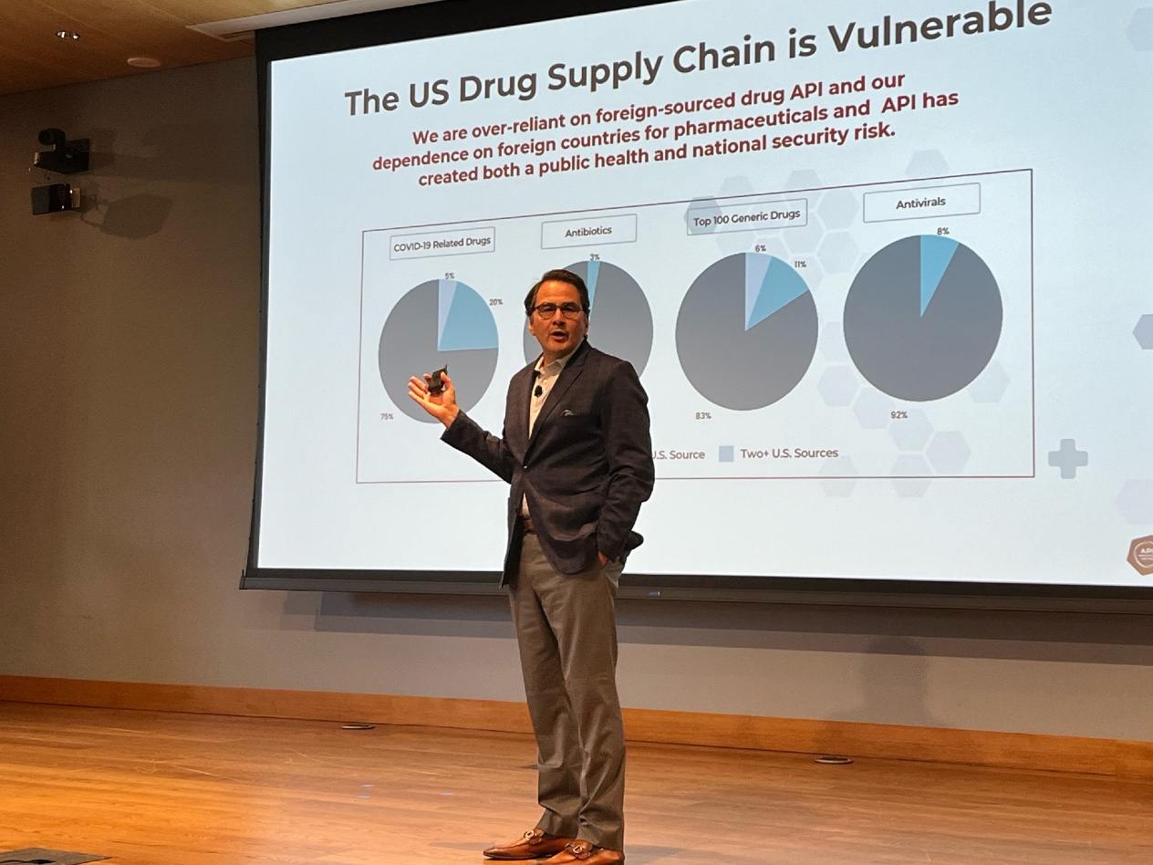 Tony Sardella stands in front of a projected image showing the vulnerabilities of the U.S. drug supply chain