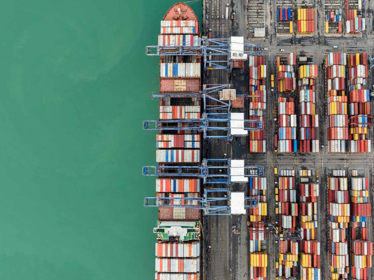 overhead view of a container ship and stacked containers