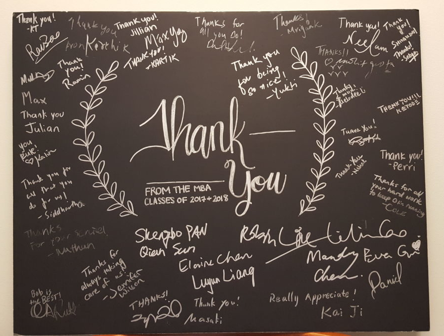 A poster size thank you card signed by MBA students.