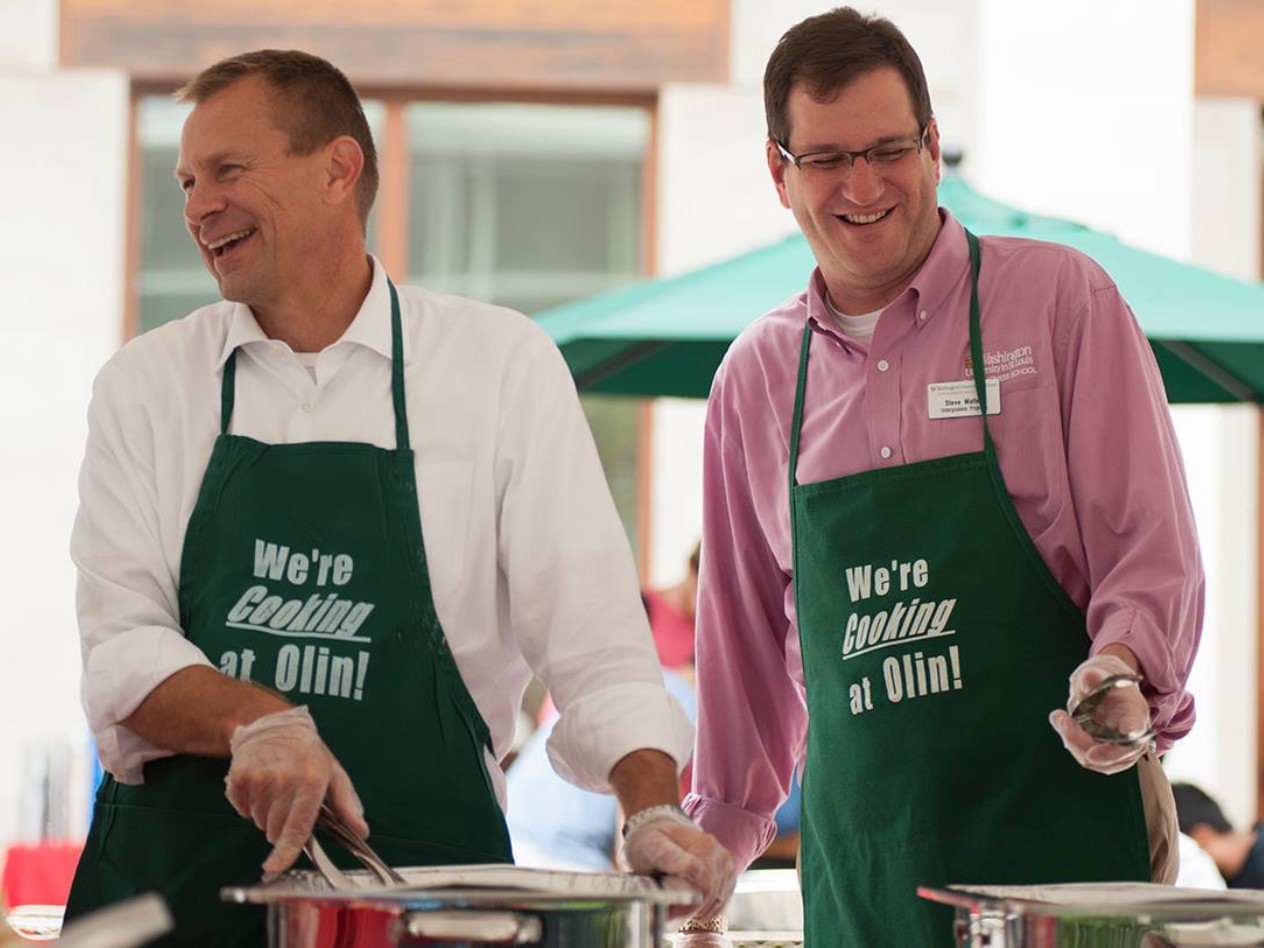 Dirks with Steve Malter serving a meal for Olin students.