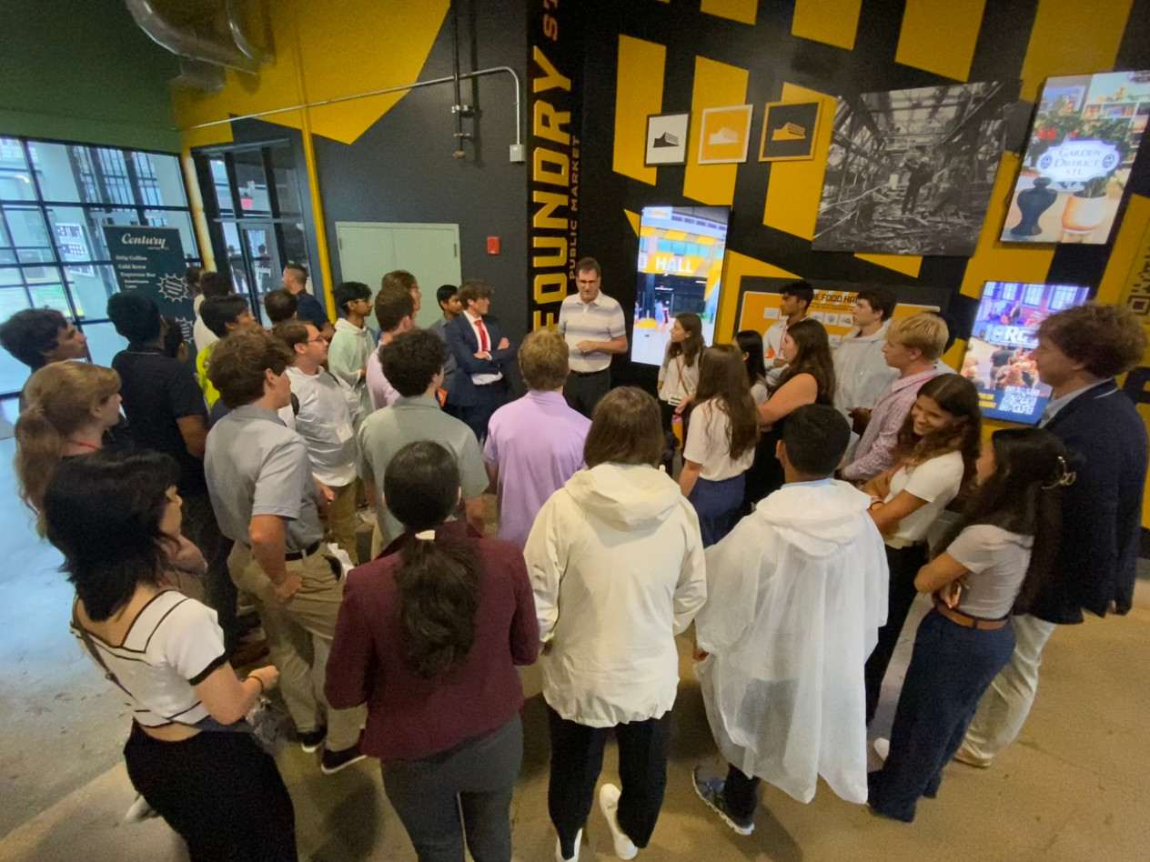 A group of students stands in a building